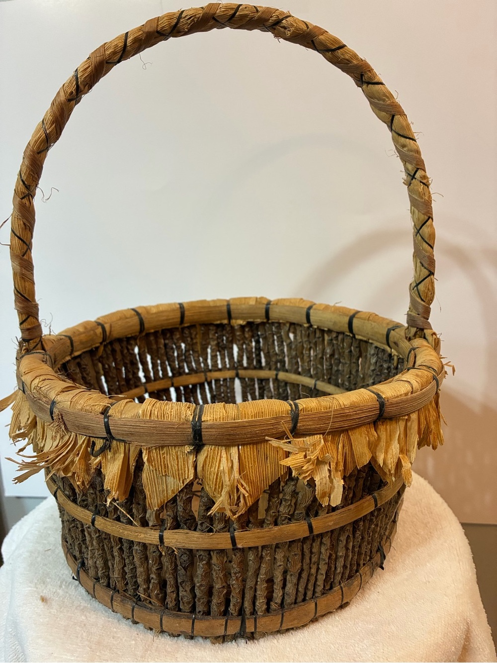 Handcrafted rustic corn husk and twig folk art basket